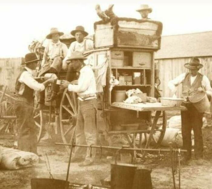 Workers drinking tea around a horse drawn cart