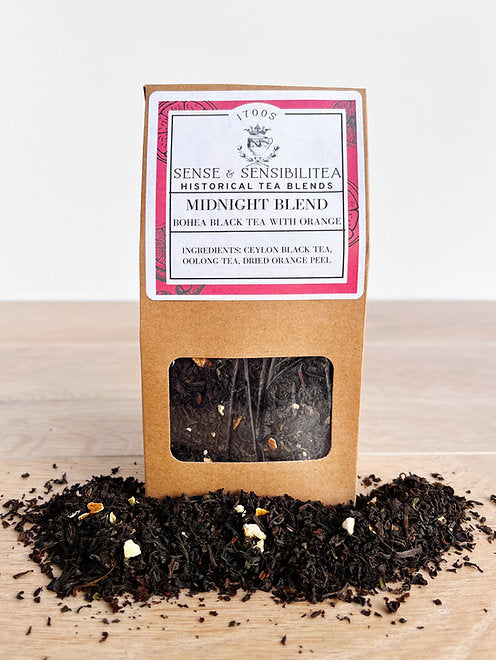 Midnight Blend Tea package surrounded by tea leaves