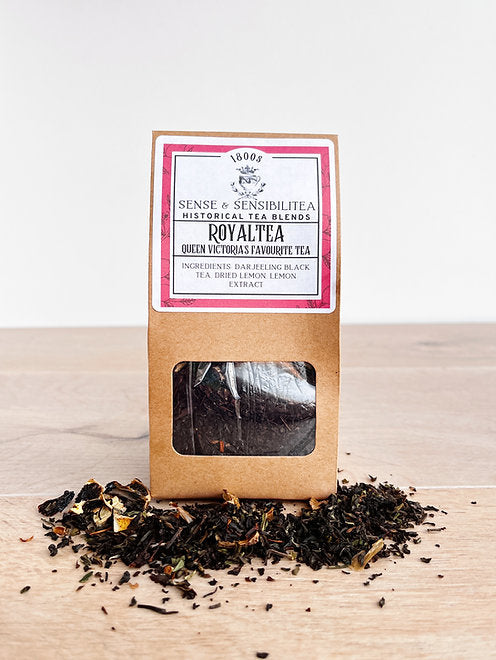 RoyalTea tea blend package surrounded by loose tea leaves