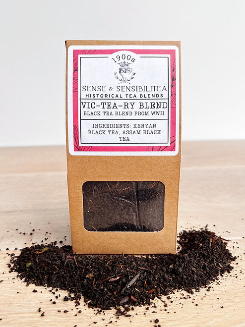 VicTeary tea blend package surrounded by loose tea leaves