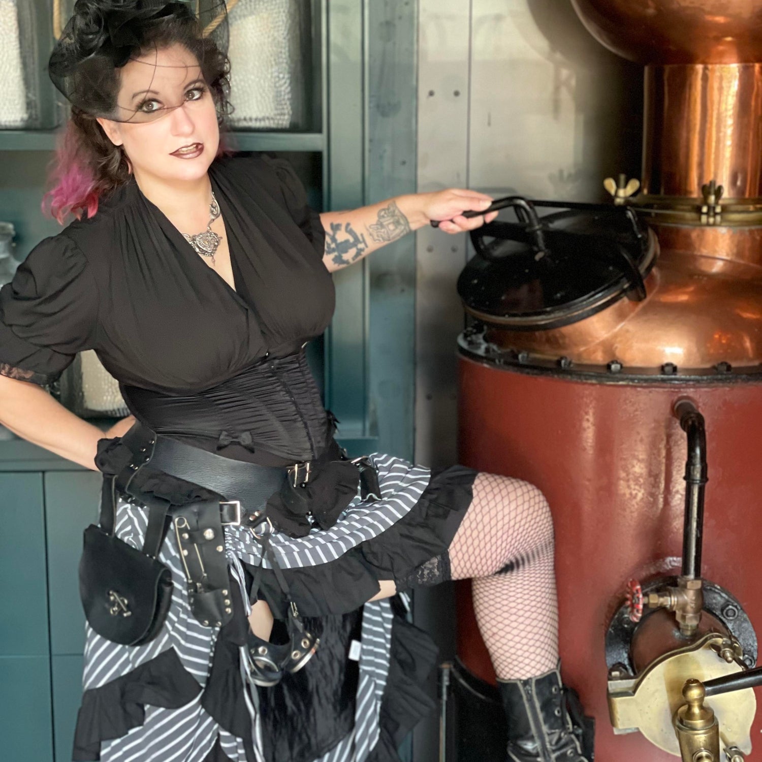 Wanda, the founder of the teapothecary, posing in a black dress