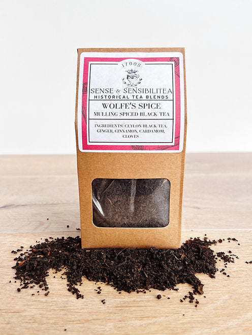 Wolfe's spice tea package surrounded by tea leaves